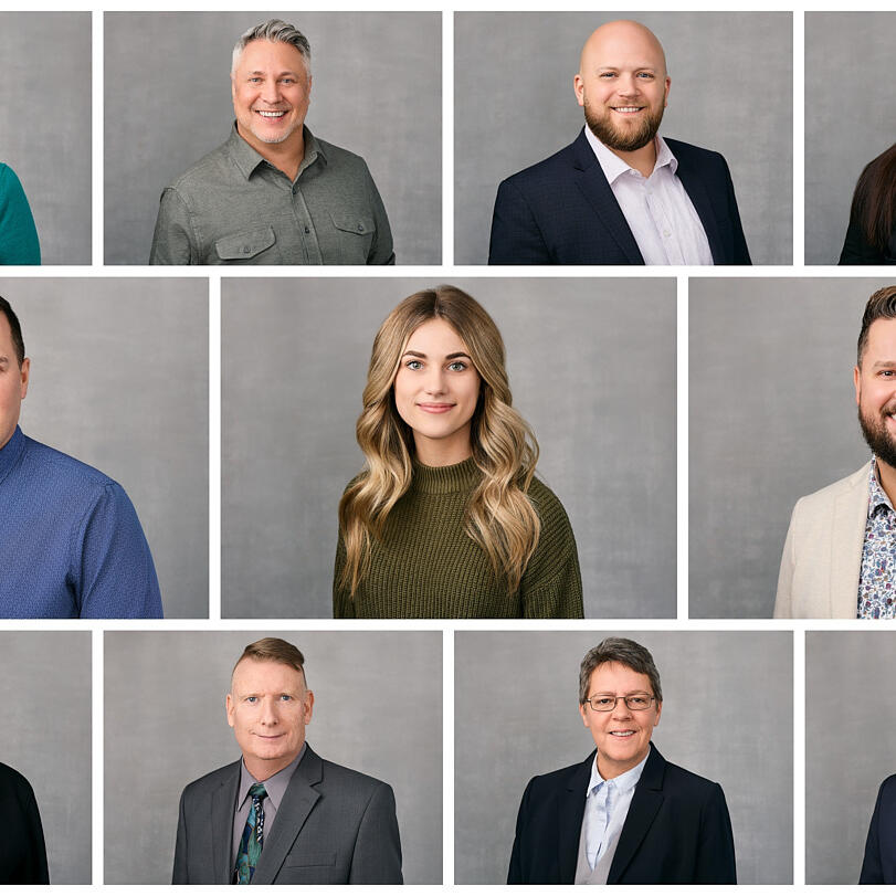 A professional headshot of Tillicum Agencies team members dressed in business attire with a modern and professional appearance against a light grey background in Maple Ridge.